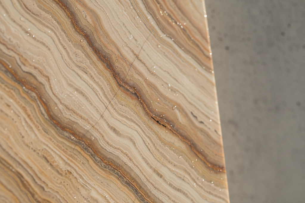 Macro detail of natural travertine veining and honed surface